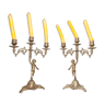 Pair of symmetrical cherub candlestick in bronze
