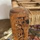 Low stool with carved wood and braided cord.