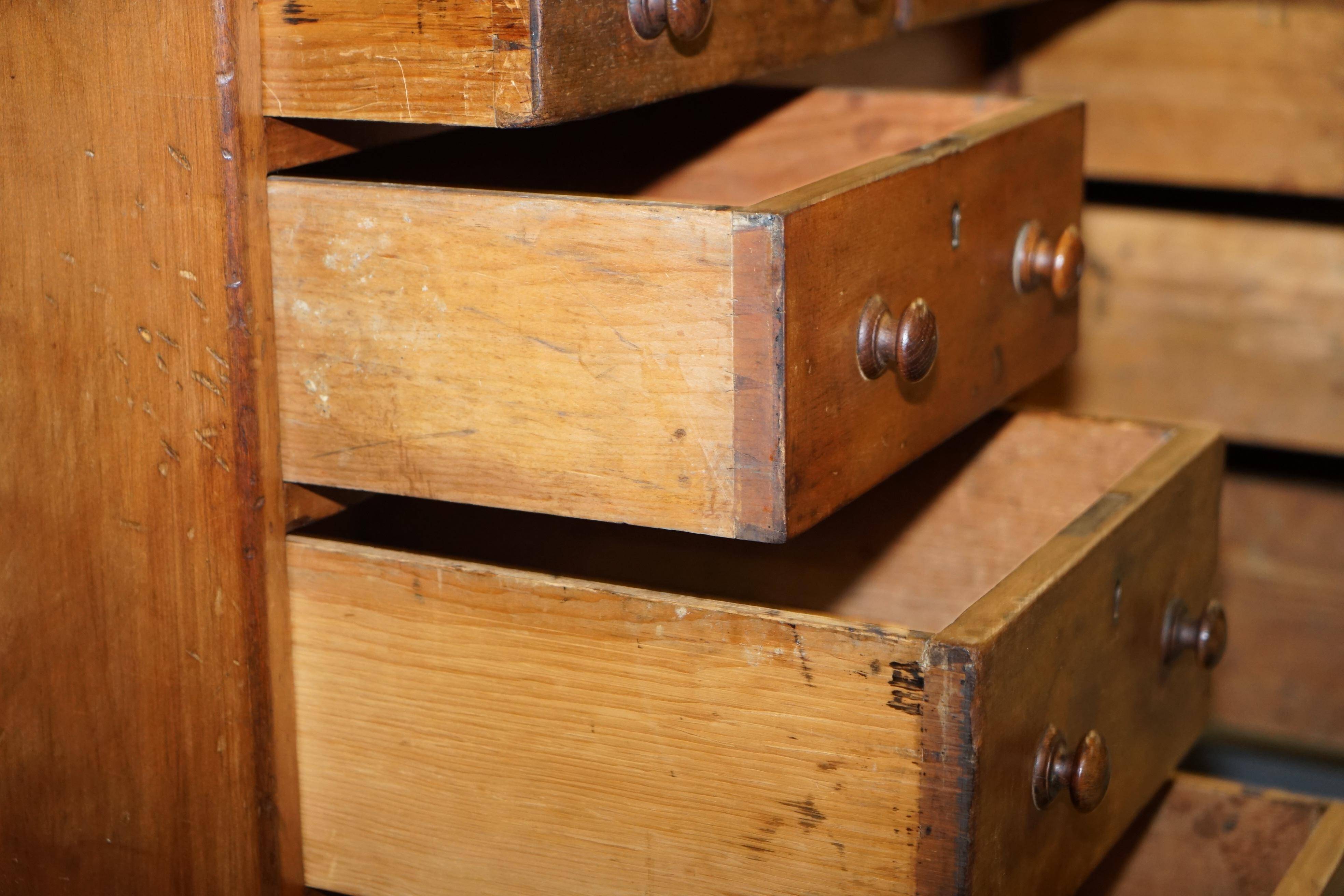 Antique Victorian oak kneehole desk with 18 double-sided drawers.