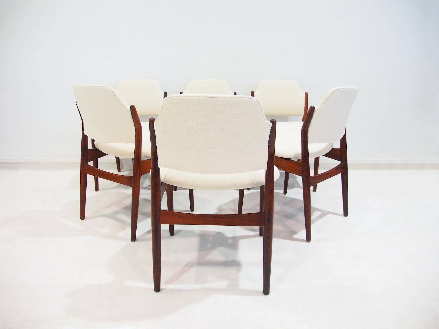 Set of six hardwood chairs by Arne Vodder for Sibast with white textile upholstery.
