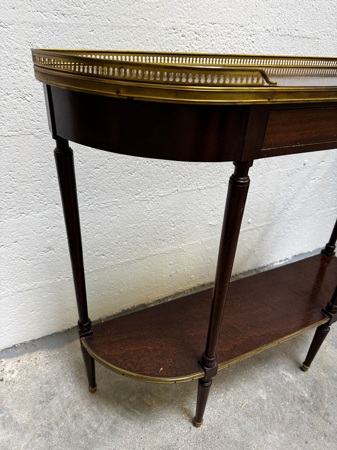 Louis XVI demi-moon console in wood and brass.
