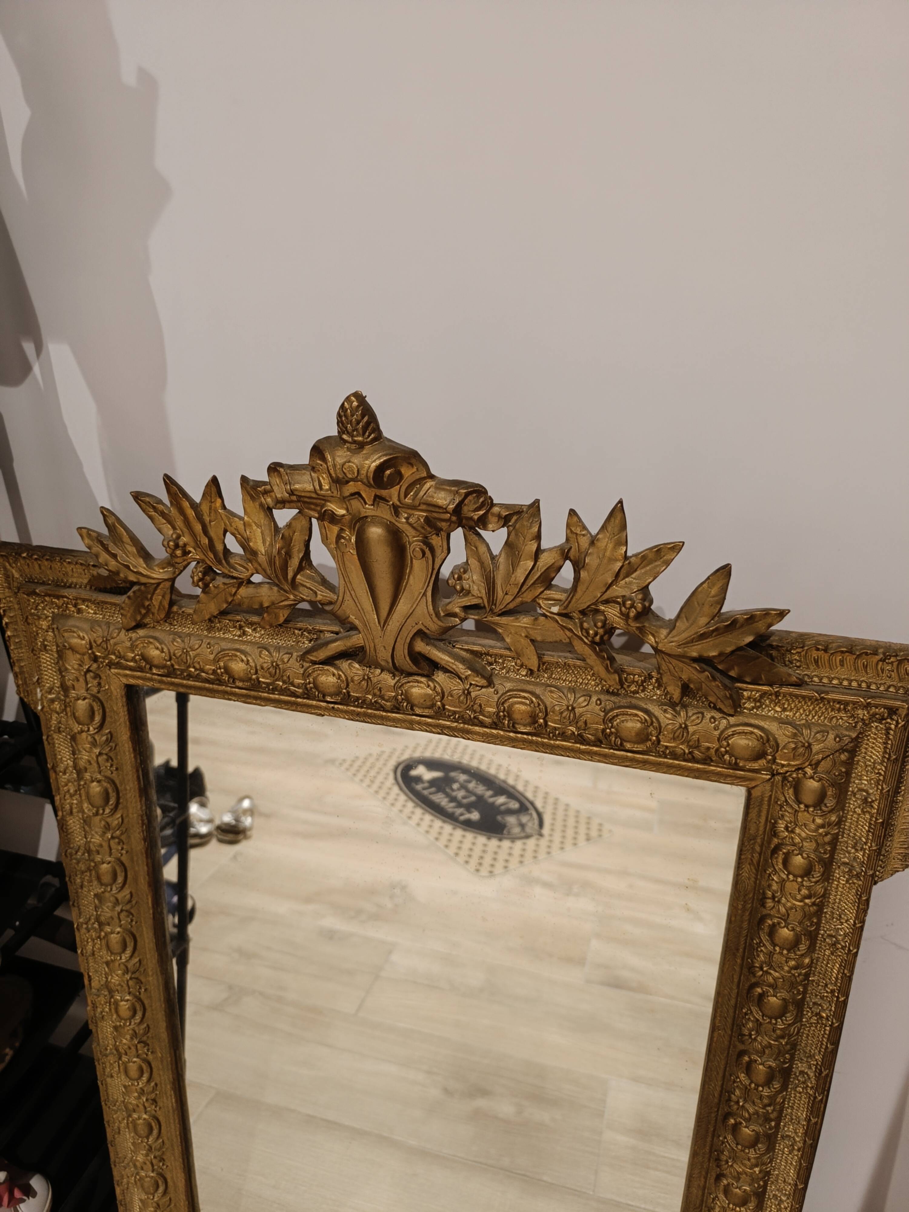 Antique mirror in Napoléon III style with a laurel pediment.
