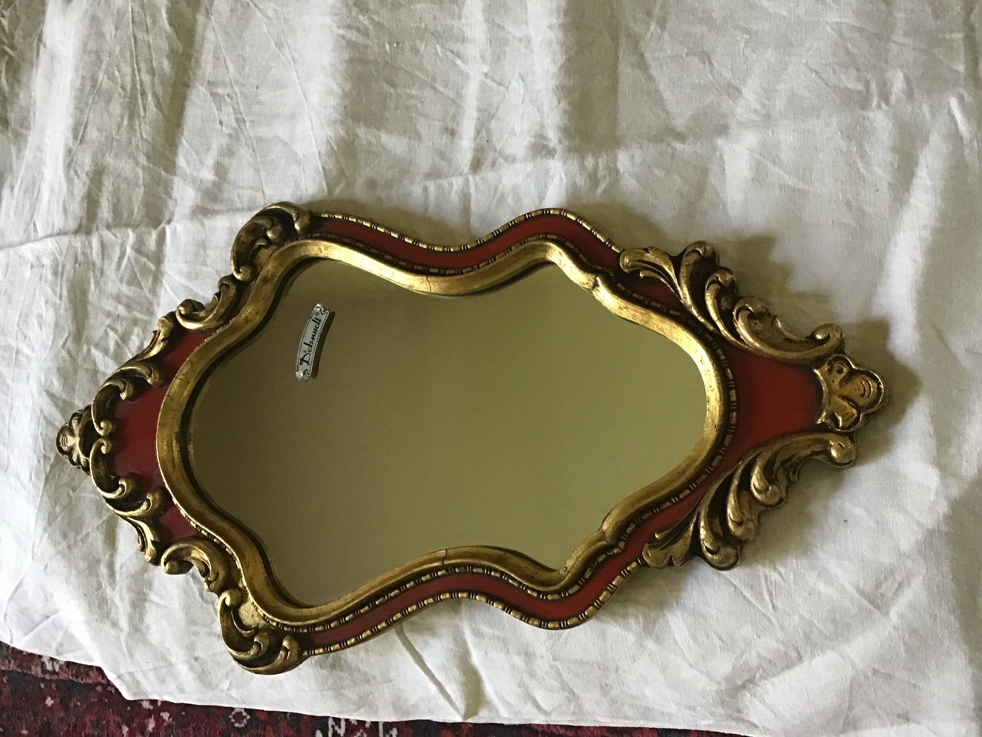 Gold and red mirror brand Deknudt