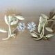 Pair of gilded metal candle holders and tassels