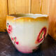 Earthenware cache pot with slip decoration.