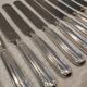 12 silver-plated Empire style table knives 25.3cm