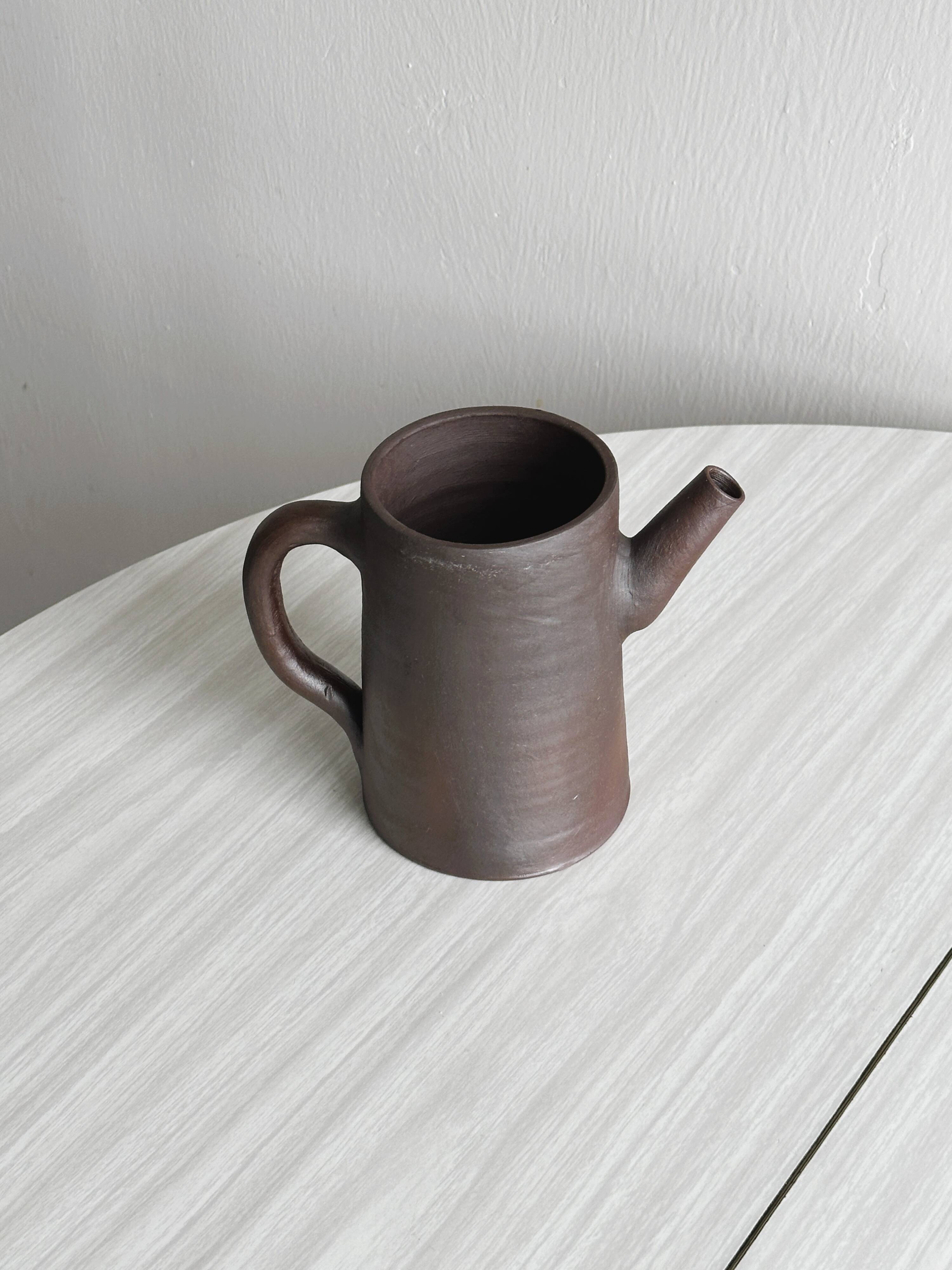 Small pitcher in brown glazed stoneware