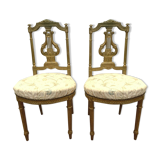 Paire de chaises de style Louis XVI en bois doré XX siècle