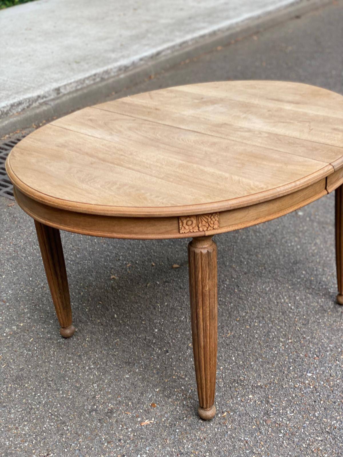 Large stripped solid oak dining table in Louis XVI style with 3 extensions.