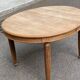 Large stripped solid oak dining table in Louis XVI style with 3 extensions.