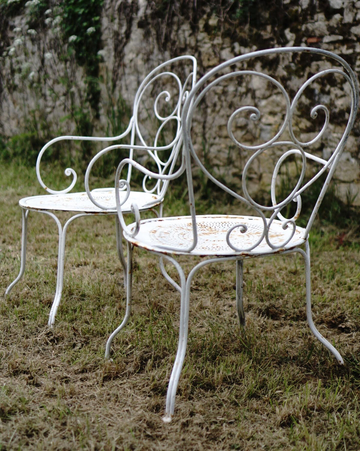 Duo of wrought iron armchairs