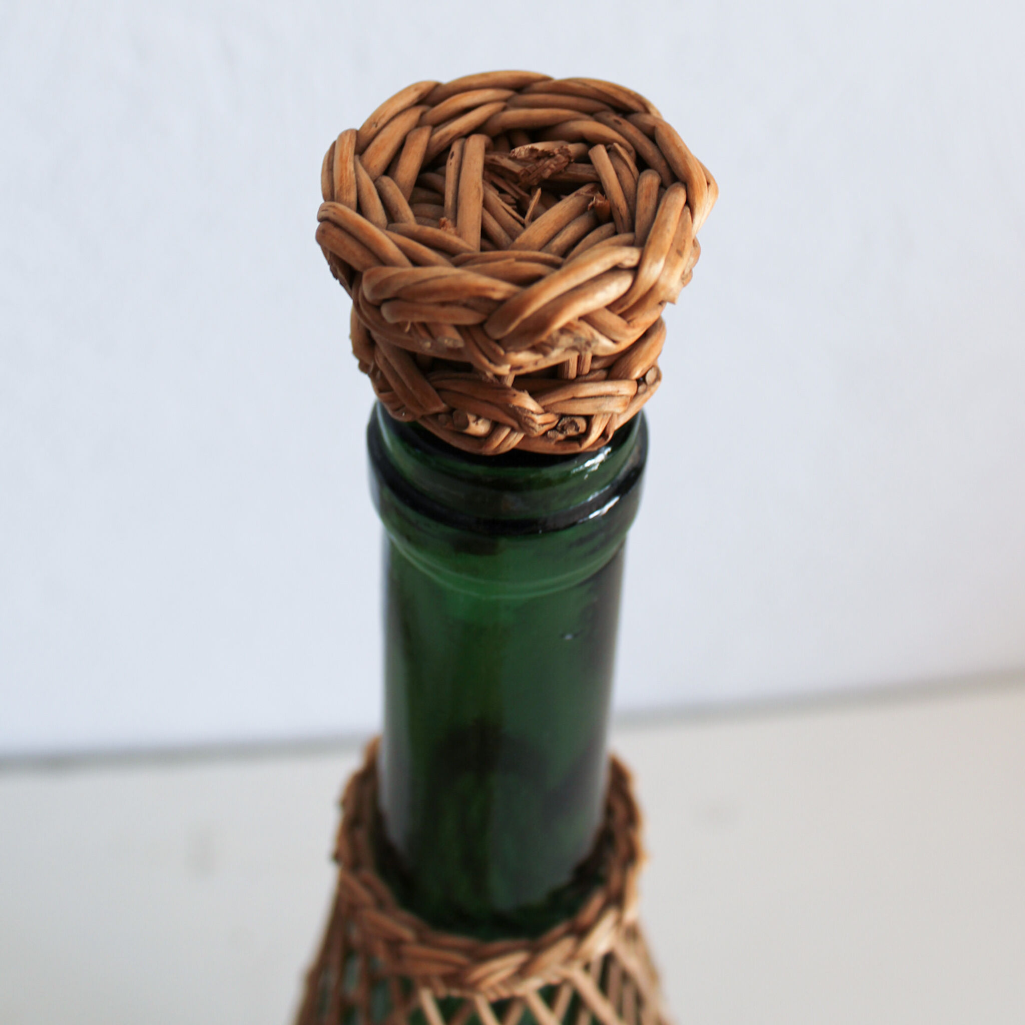 Glass and wicker bottle