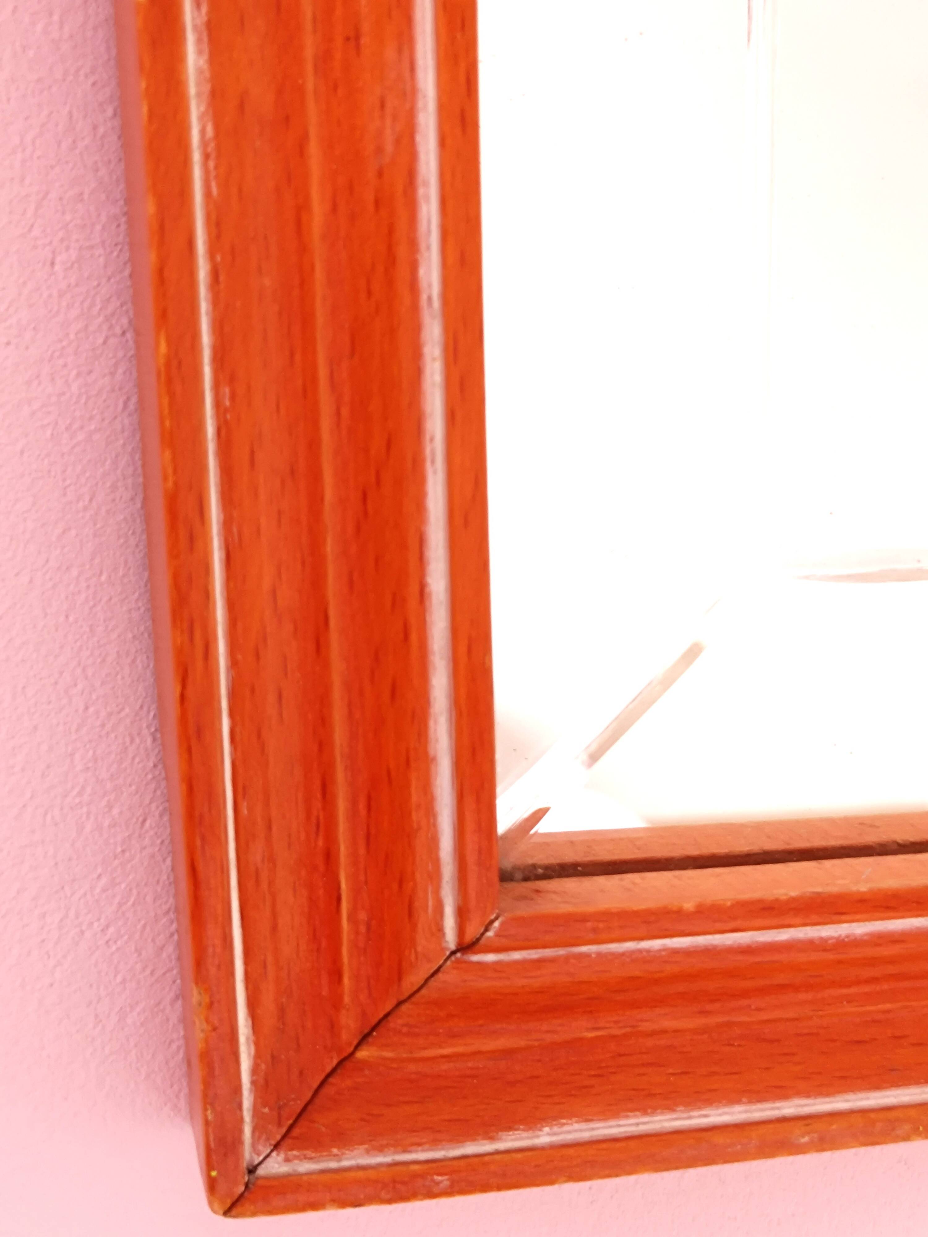 Beveled glass wall mirror in solid wood frame