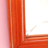 Beveled glass wall mirror in solid wood frame