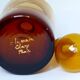 Decorated and signed perfume bottle, brown glass, painted "by hand Clary Paris"
