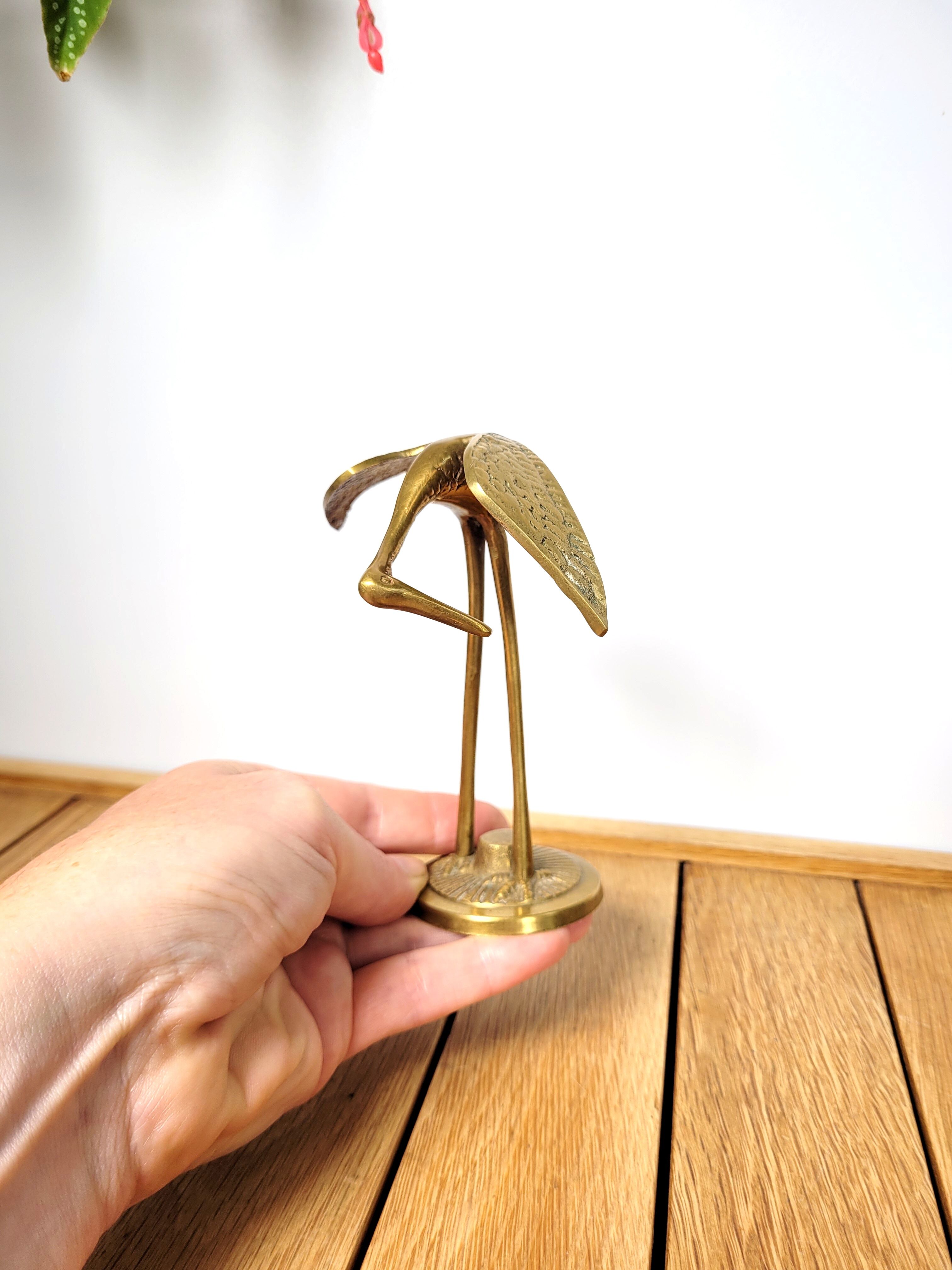 Brass heron head down