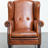 Wingback chair made of sheep leather with black piping in good condition