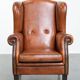 Wingback chair made of sheep leather with black piping in good condition
