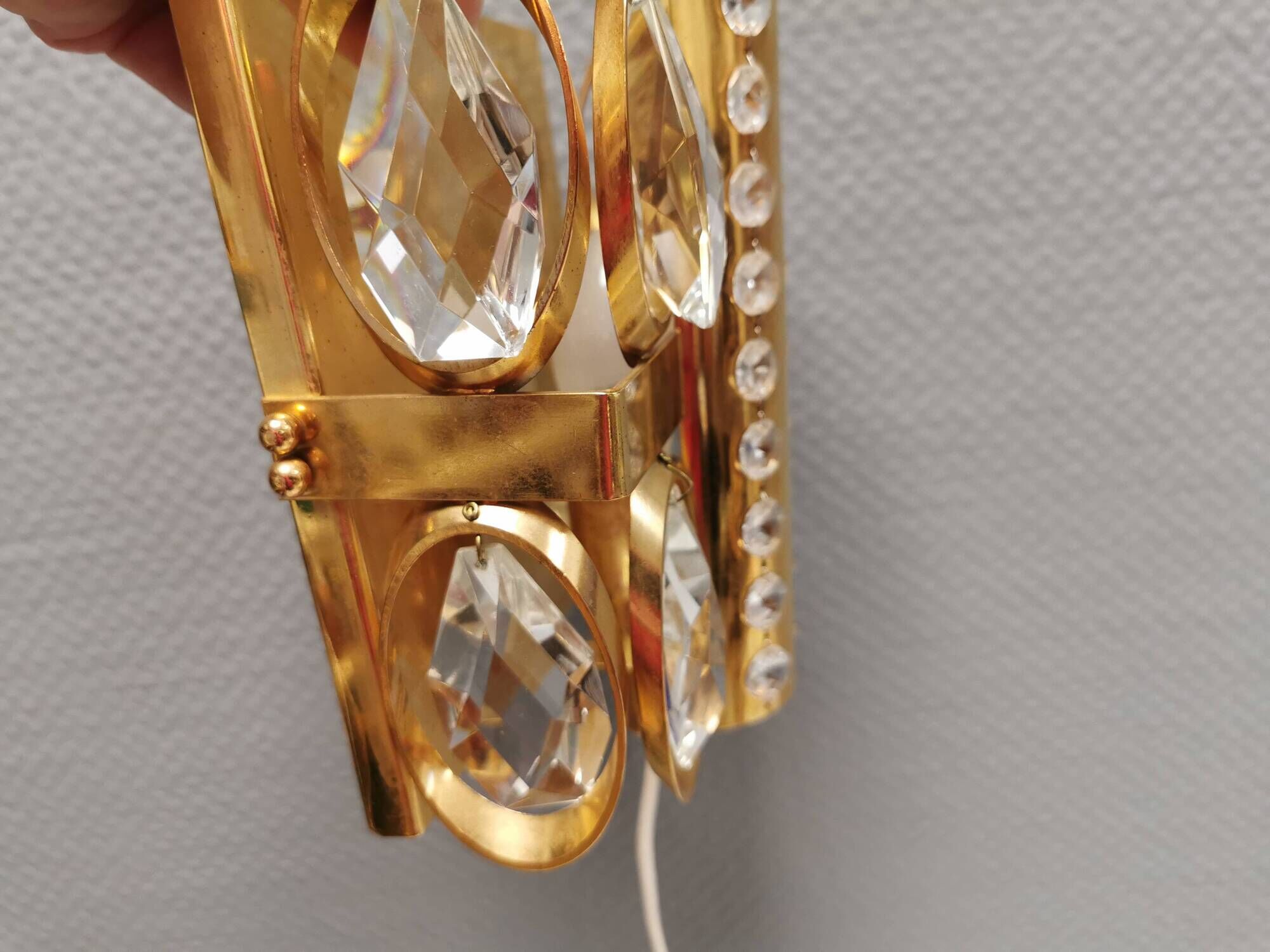 Swedish wall lamp in gold-colored metal with glass prisms. Estimated 1970-80s.