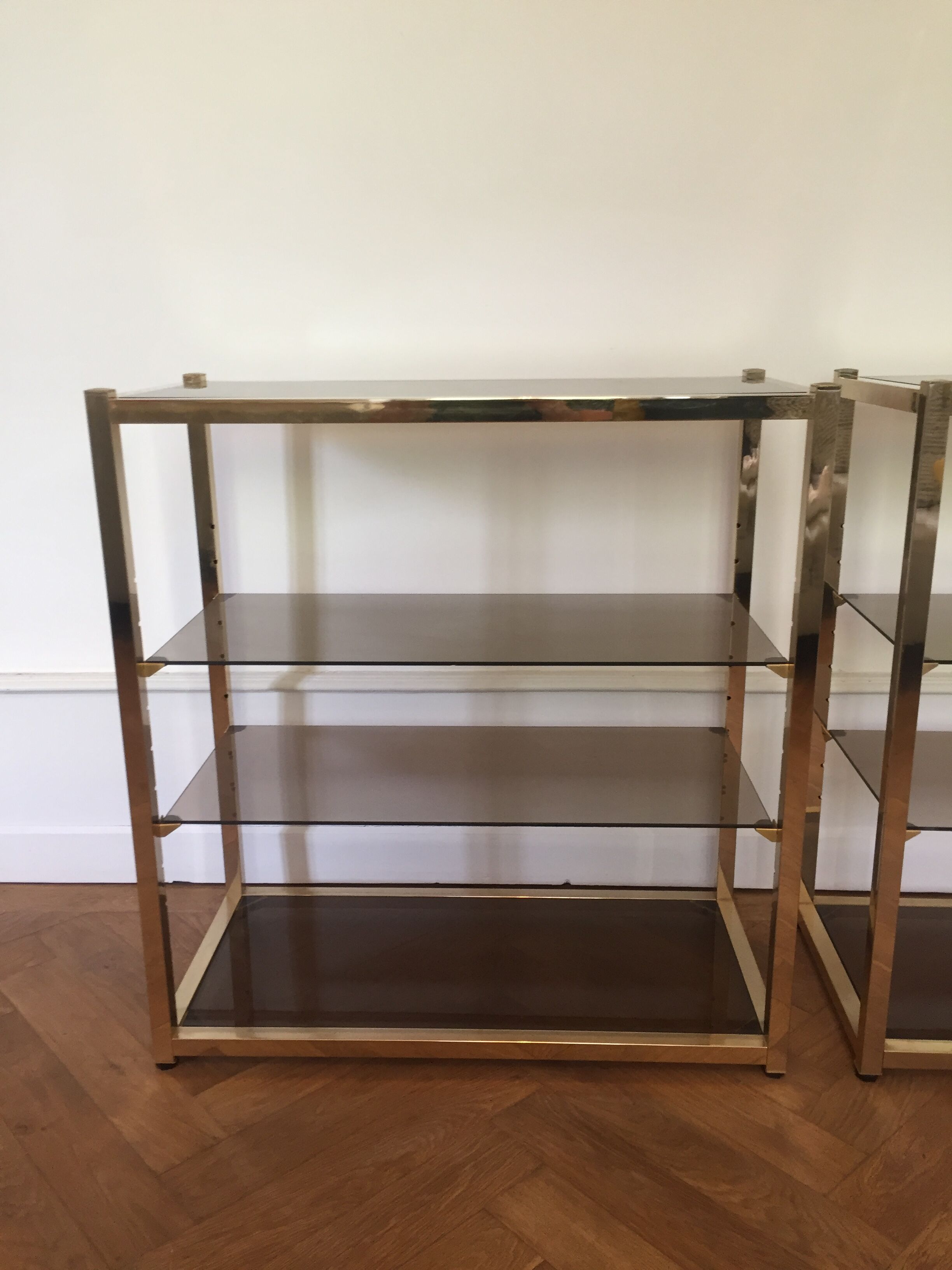Pair of consoles brass shelves and smoked glass design Roche Bobois
