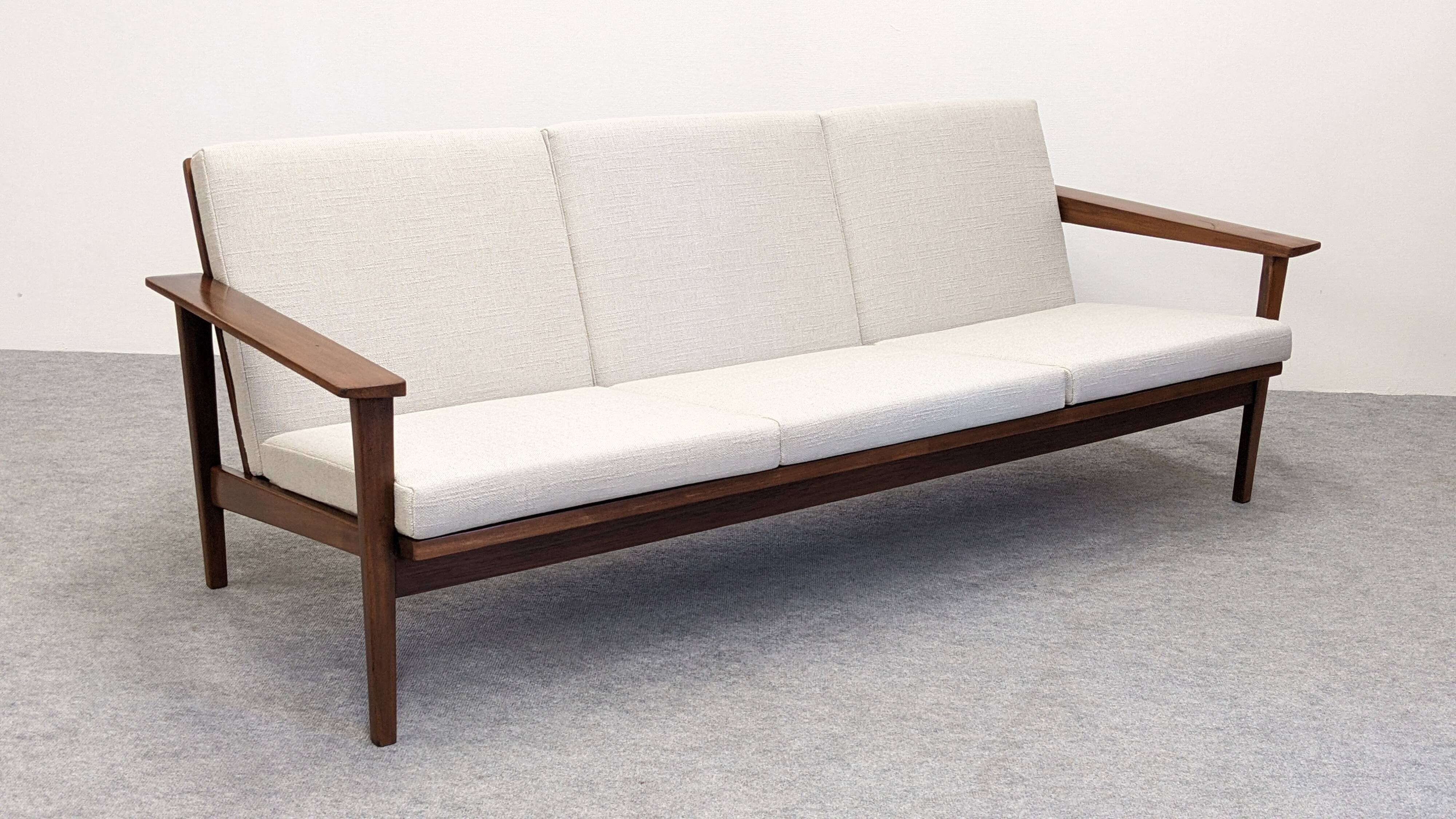 Scandinavian style three-seater sofa in teak, France circa 1950.
