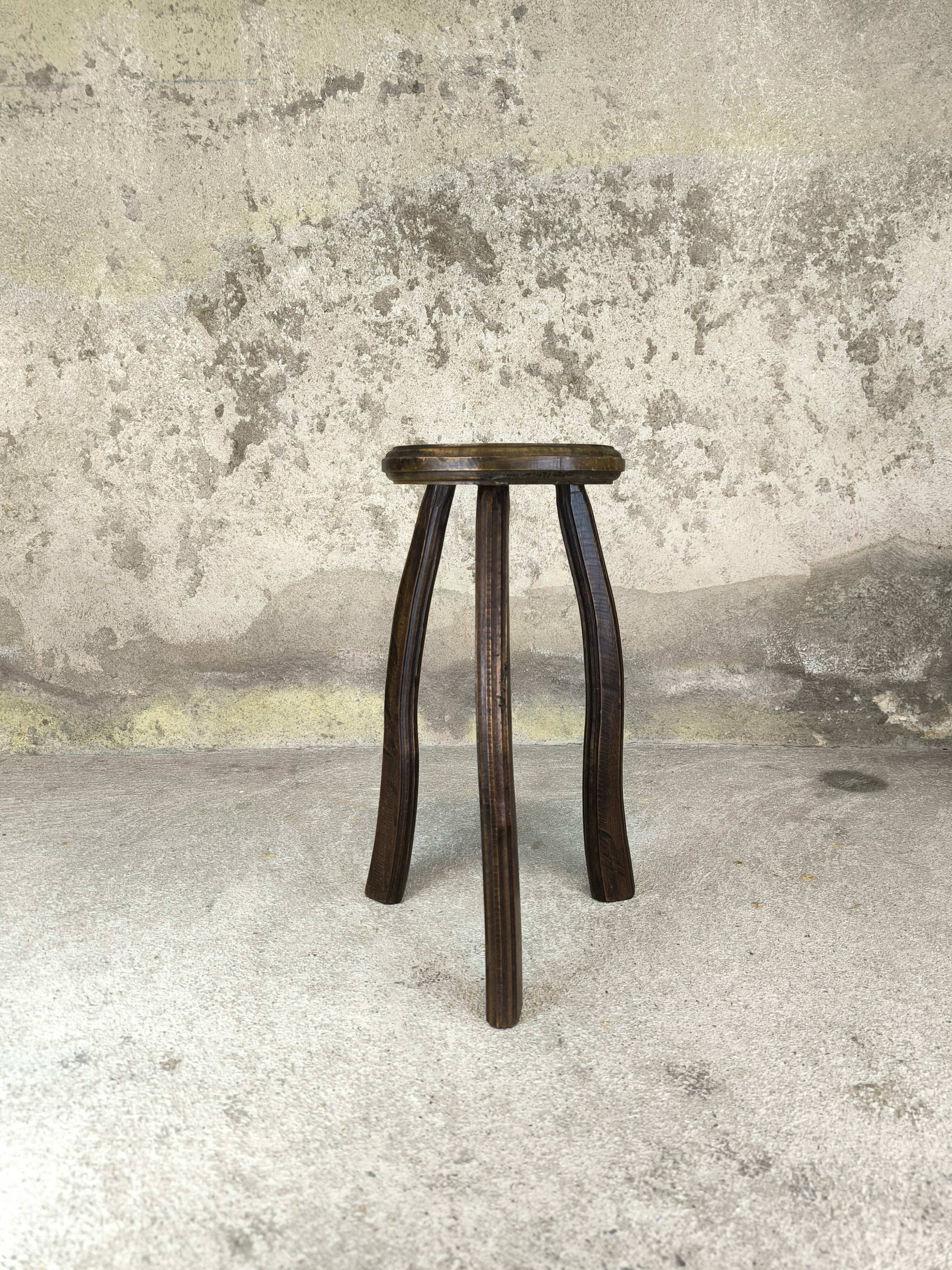 Vintage tripod plant stand with curved legs.