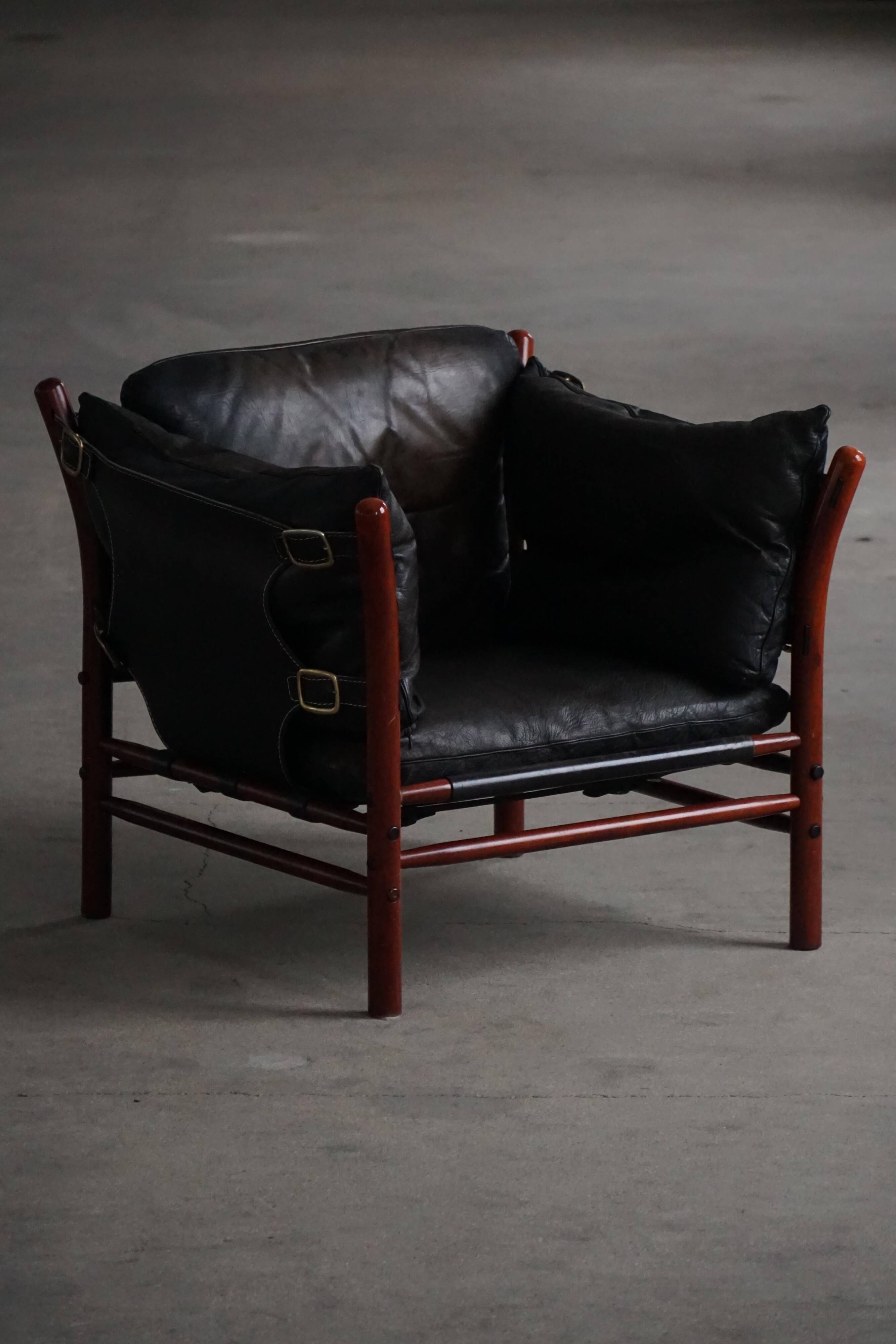 "Lounge chair 'Ilona' by Arne Norell in stained beech and leather, mid-20th century."