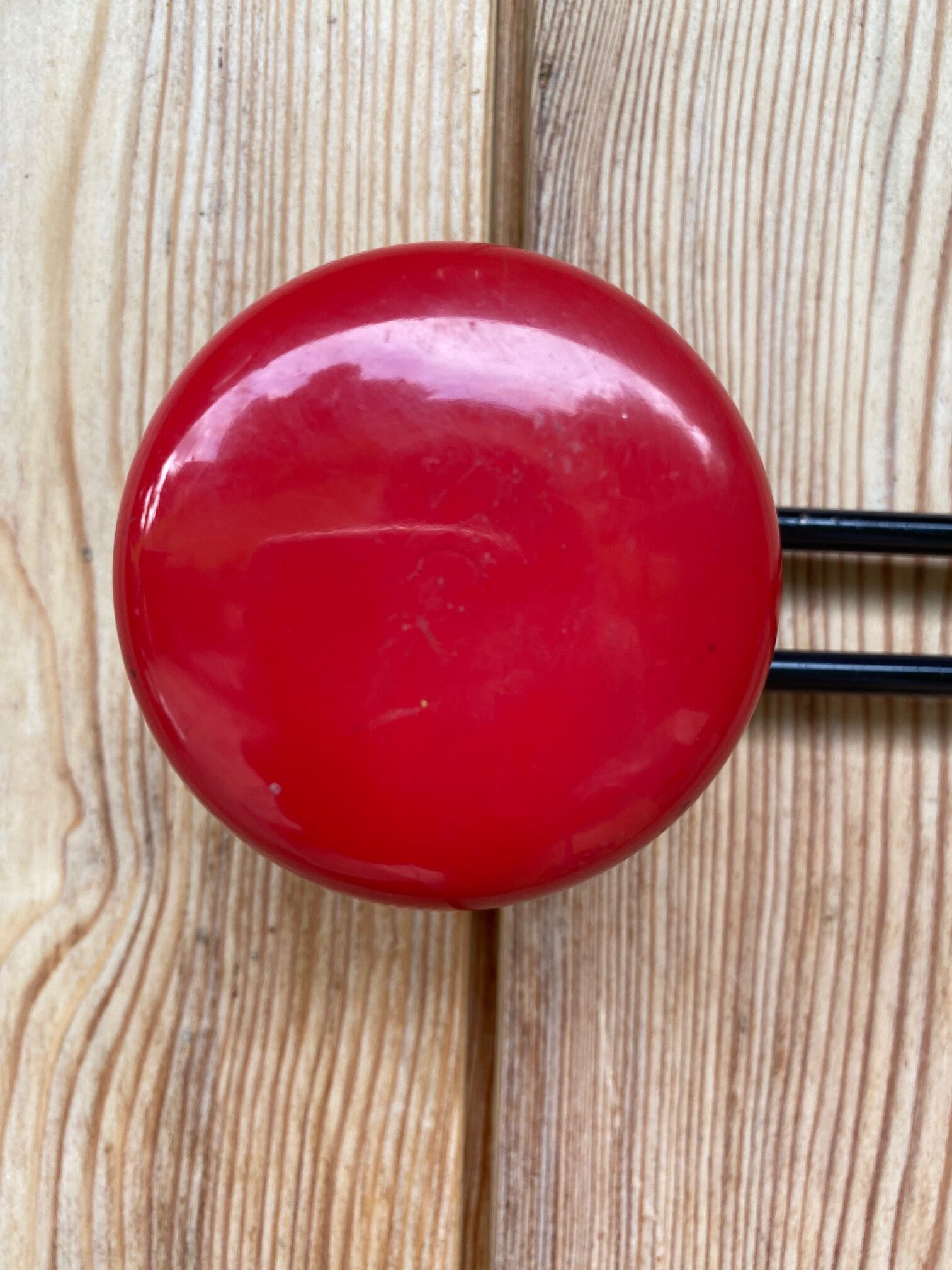 Wall coat holder in vintage red metal.