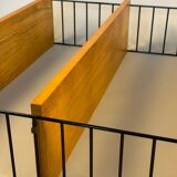 Floating wall shelf in oak veneer and black metal, 1960s.