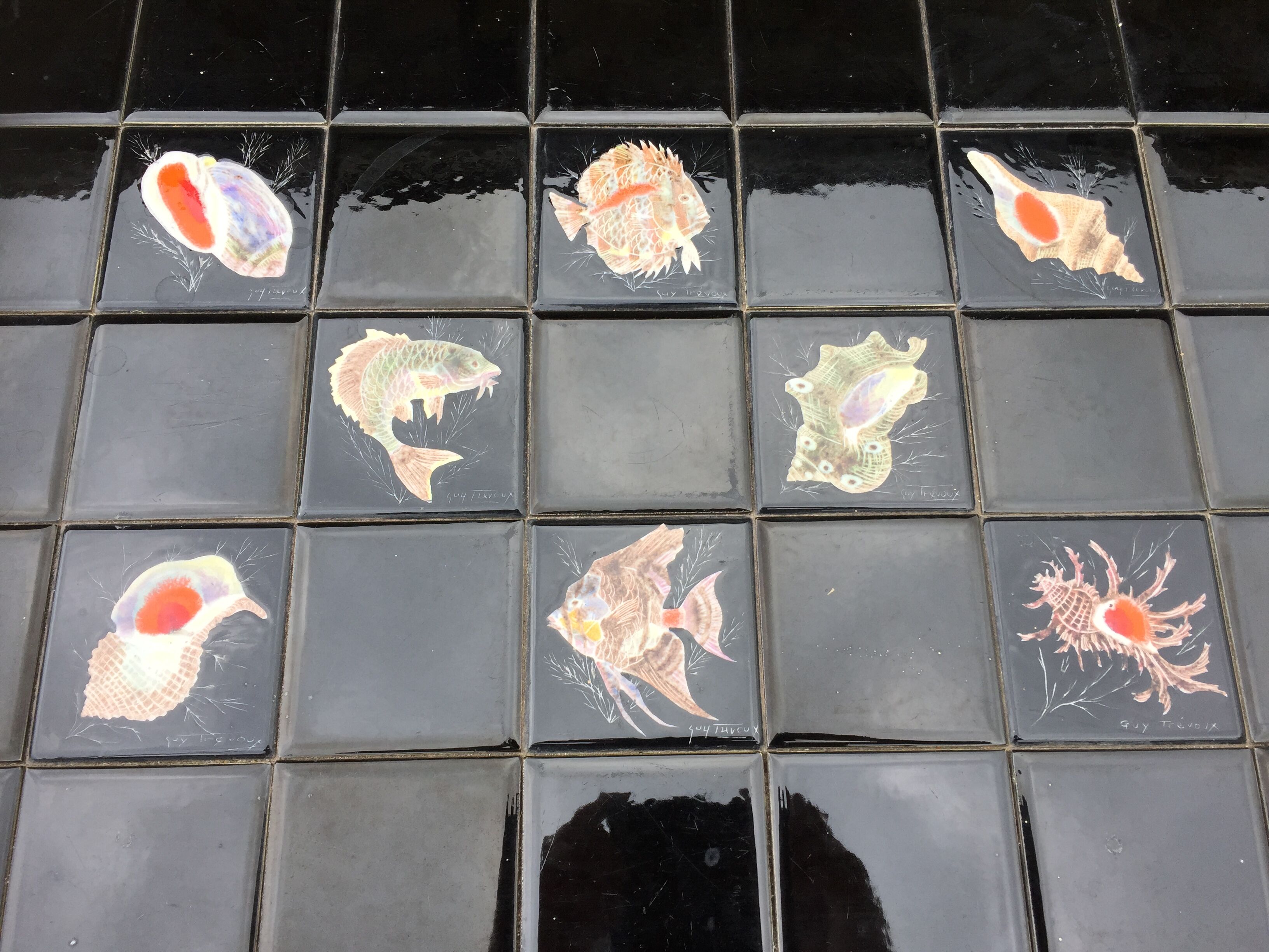 Vintage ceramic coffee table by Guy Trévoux with wrought iron base.