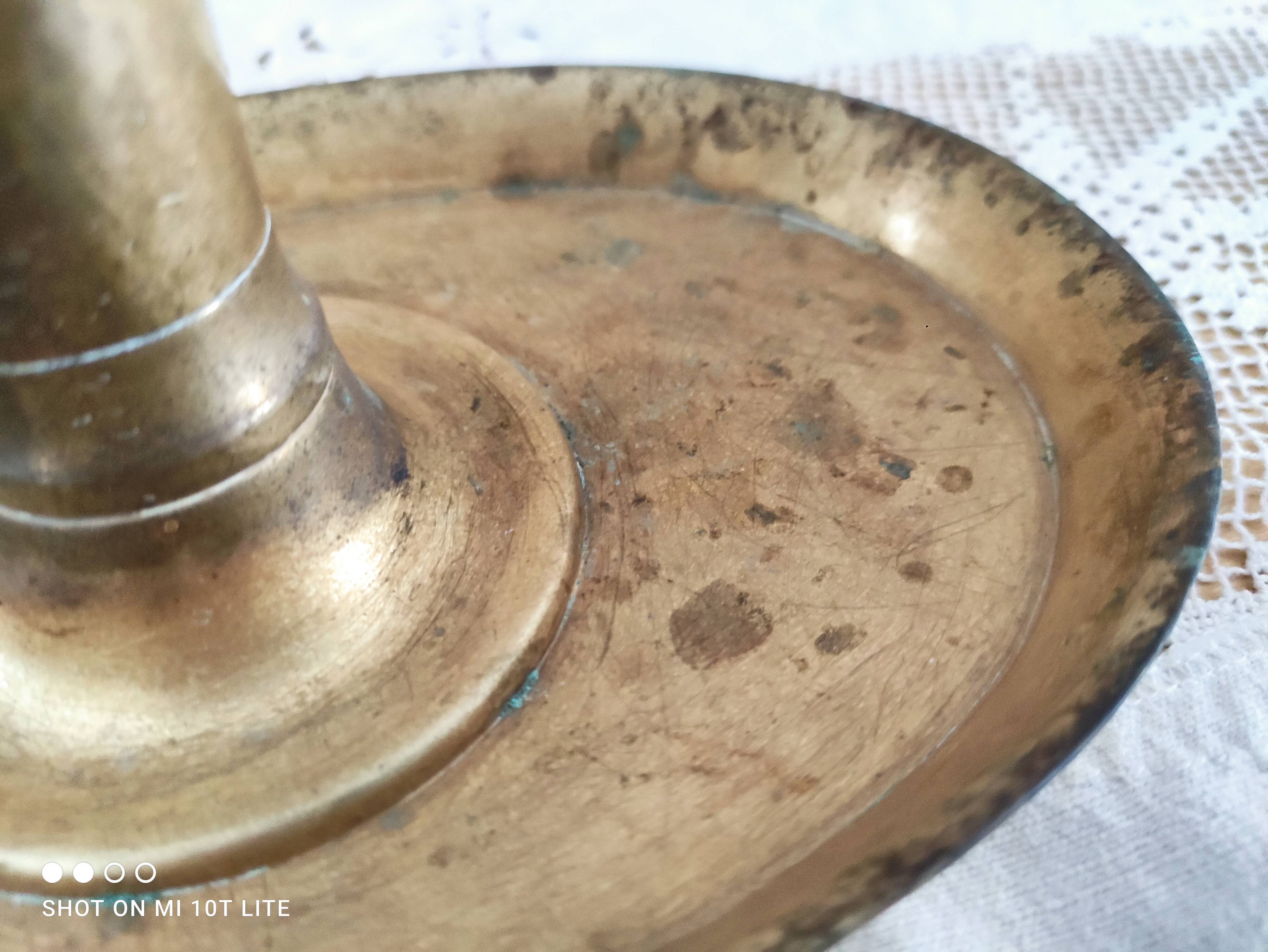 Brass pusher candle holder on oval frame