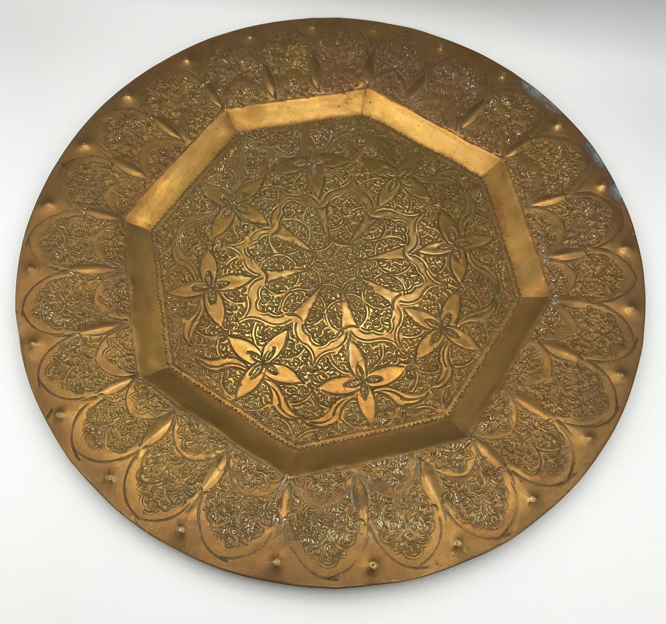 Oriental brass tray with chiseled decoration of arabesques and flowers