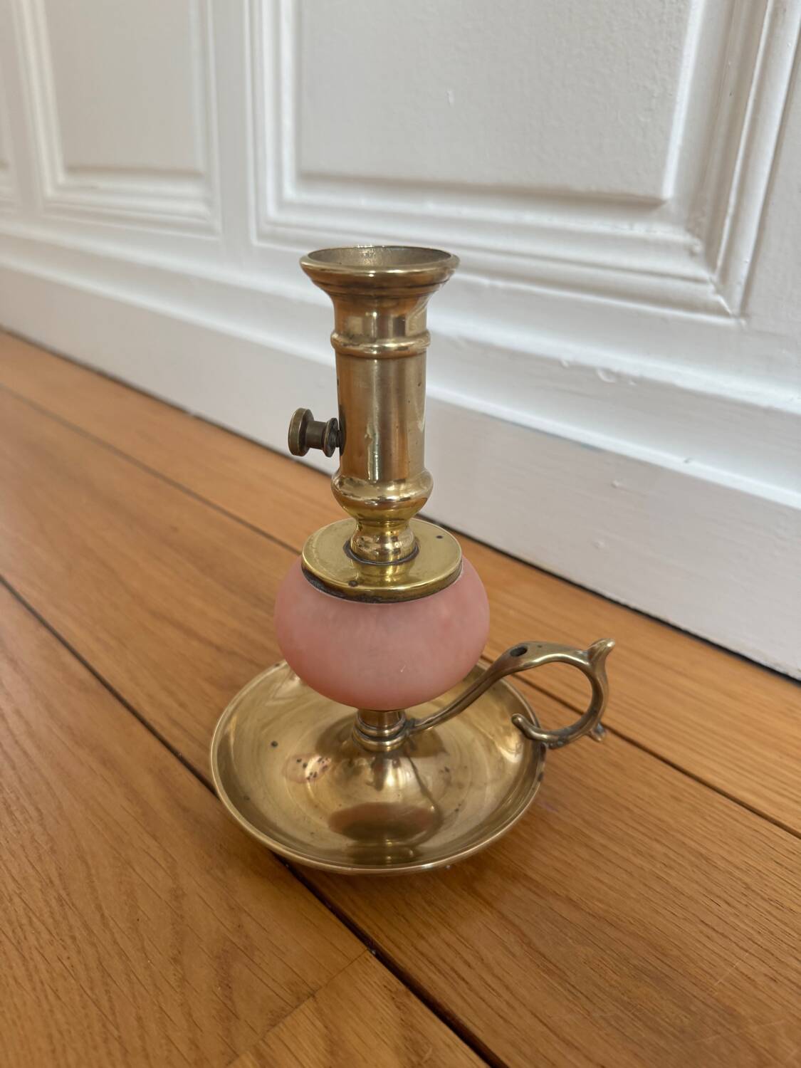 Pink glass and brass candlestick