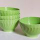 Four vintage spring green earthenware bowls