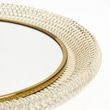 Mid Century Modern round wall mirror with a white expanded metal frame