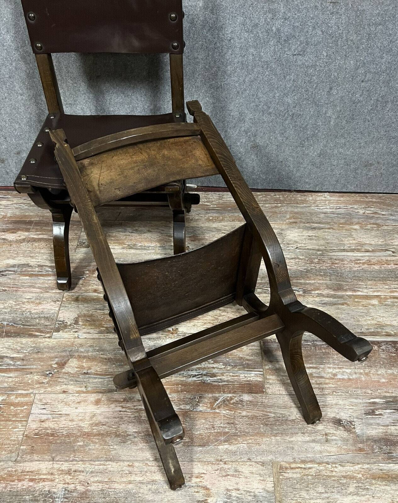 Pair of medieval style chairs in solid wood and leather, 19th century, circa 1850