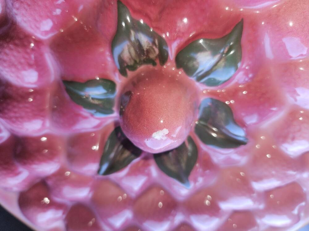 Glazed ceramic dessert plate with strawberry design.