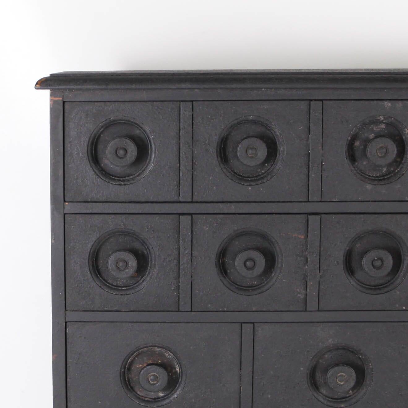 Blackened wooden chest of drawers