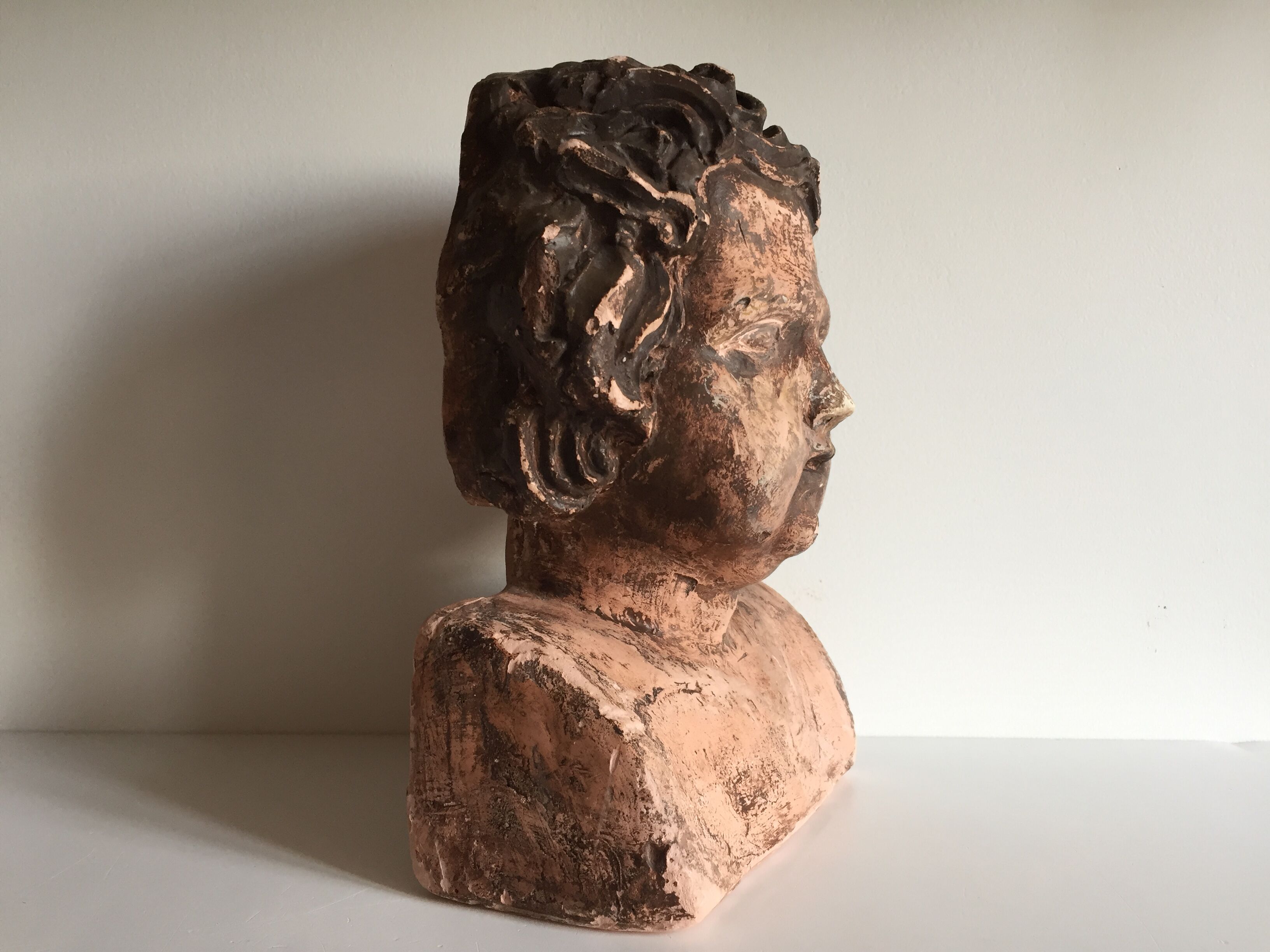 Bust old child in plaster stamped l.j.c.