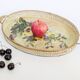 Oval metal decorative vintage tray with floral pattern.