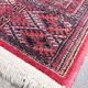 Large red Bokhara-style oriental carpet 300x200 cm with gul patterns.
