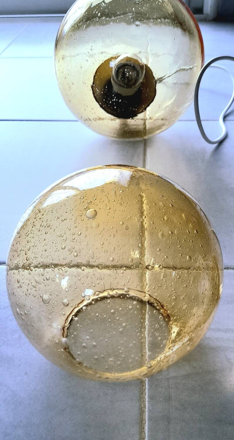 Set of 2 bubbled amber glass globe pendants
