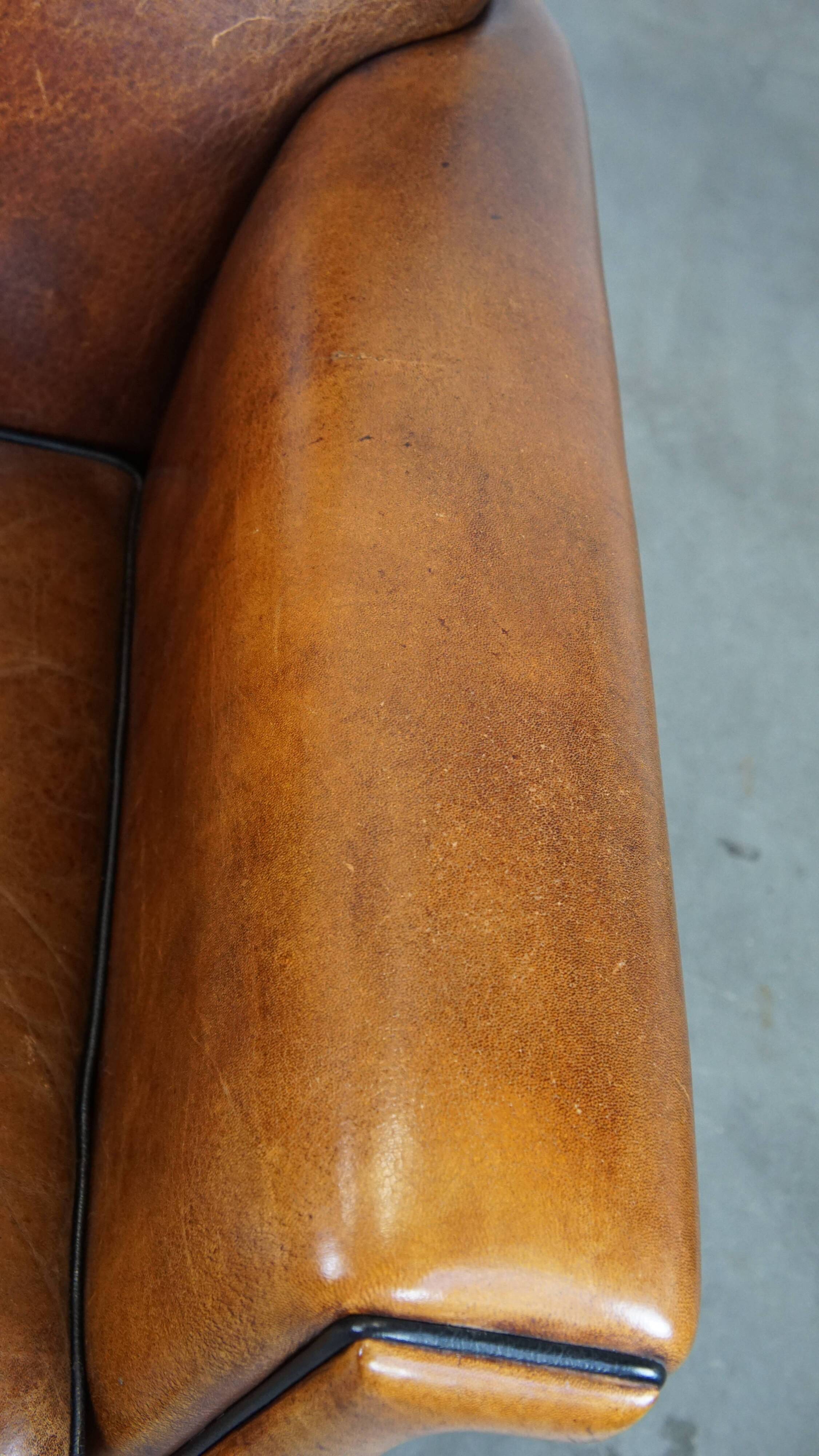 Sheep leather Art Deco design armchair finished with black piping