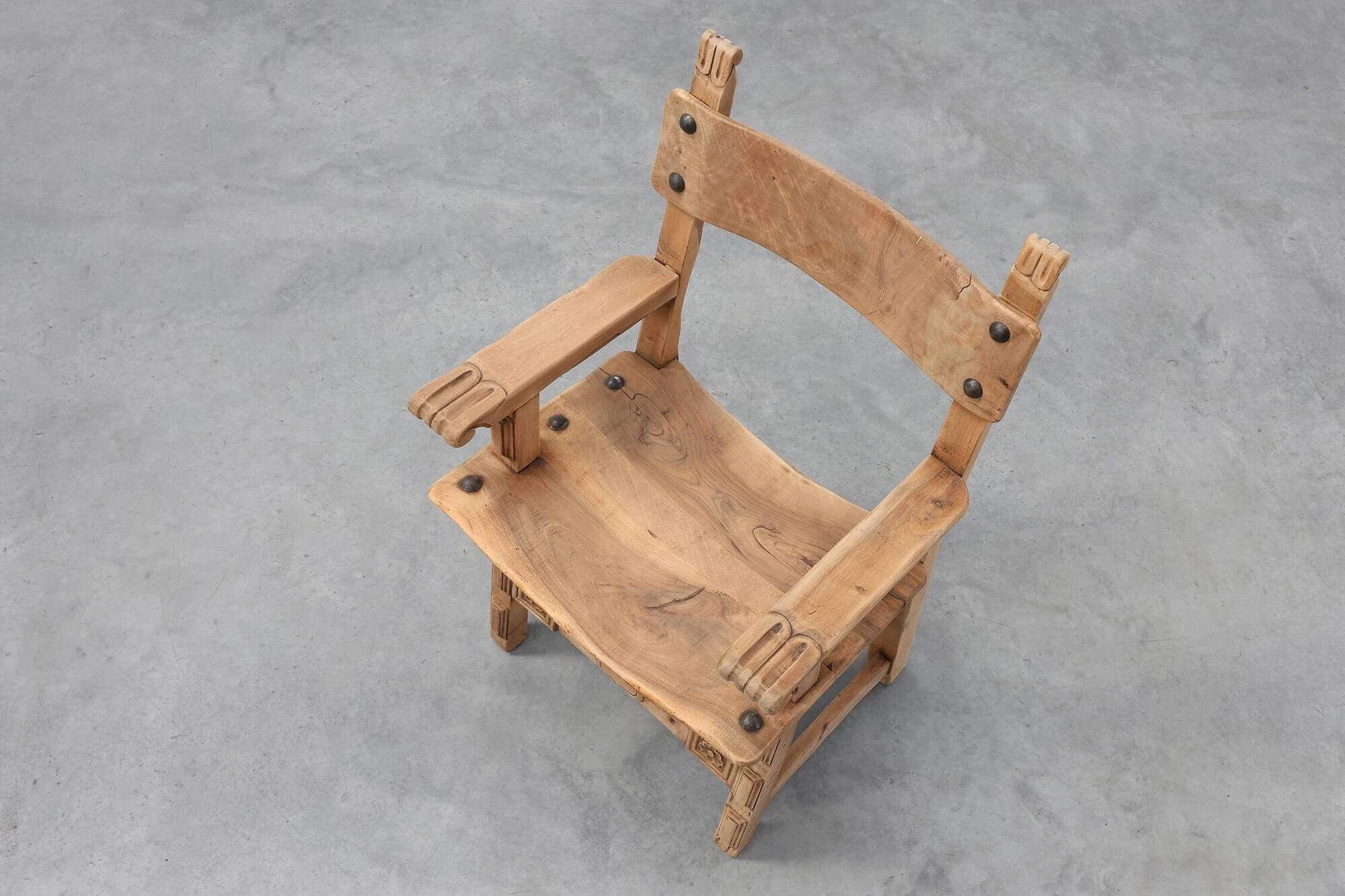 Brutalist armchair with carved rosettes and nailed wooden seat, Spain