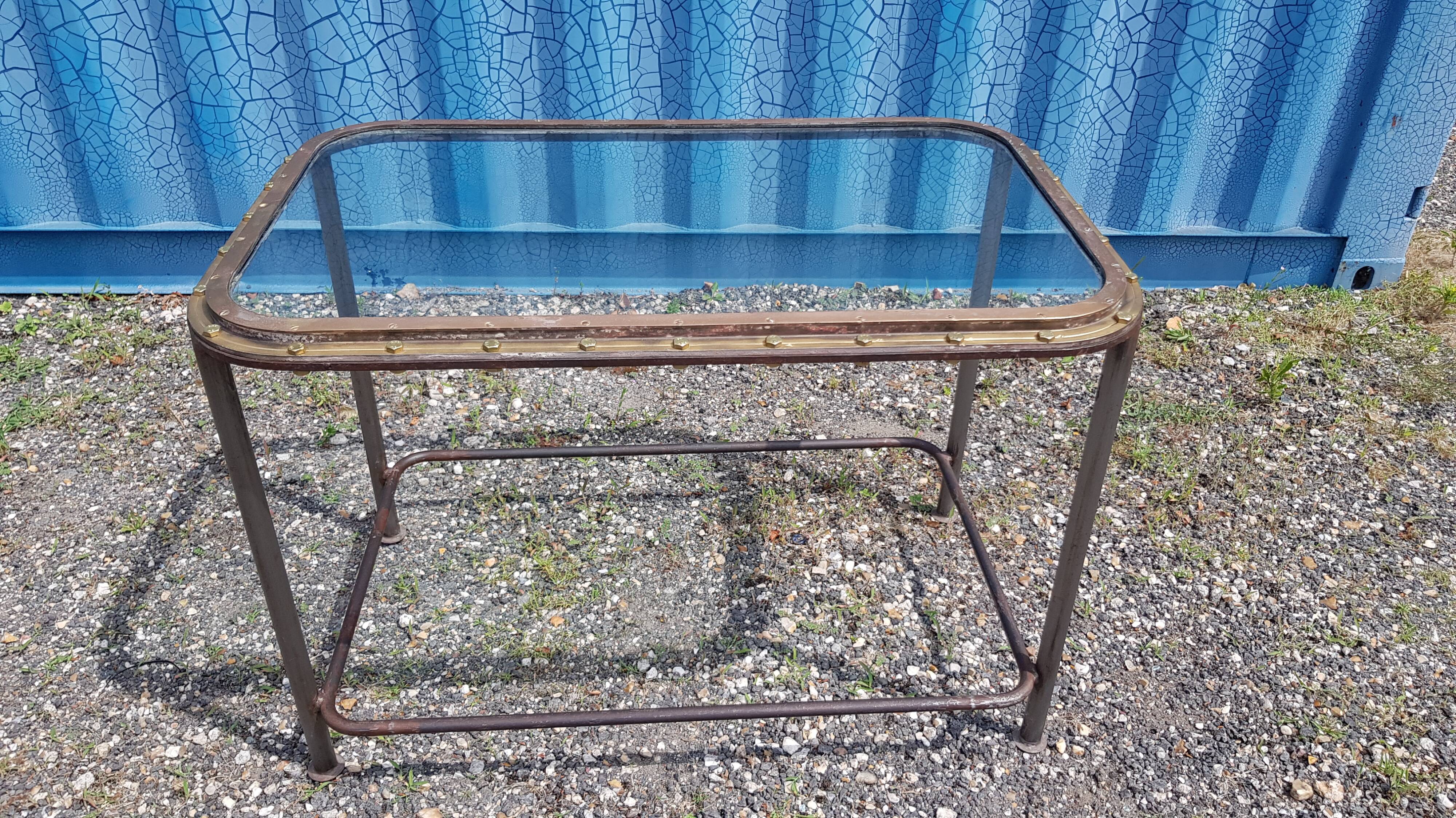 Table with an old ship porthole in brass and a metal base / 110 x 70 x 76 cm