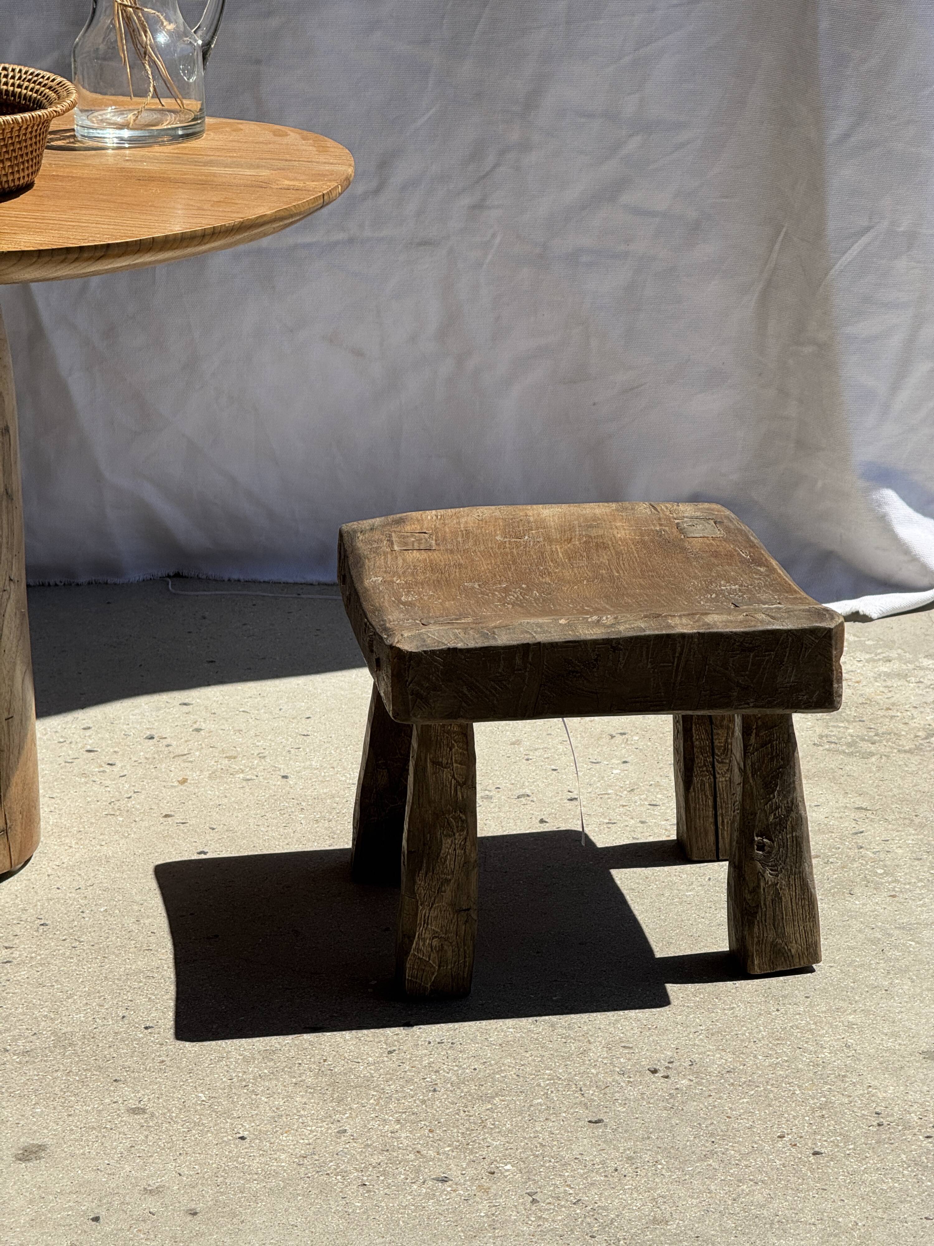 Small stool, square solid teak side table with a curved seat.