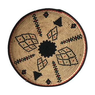 Braided wicker dish with ethnic motifs