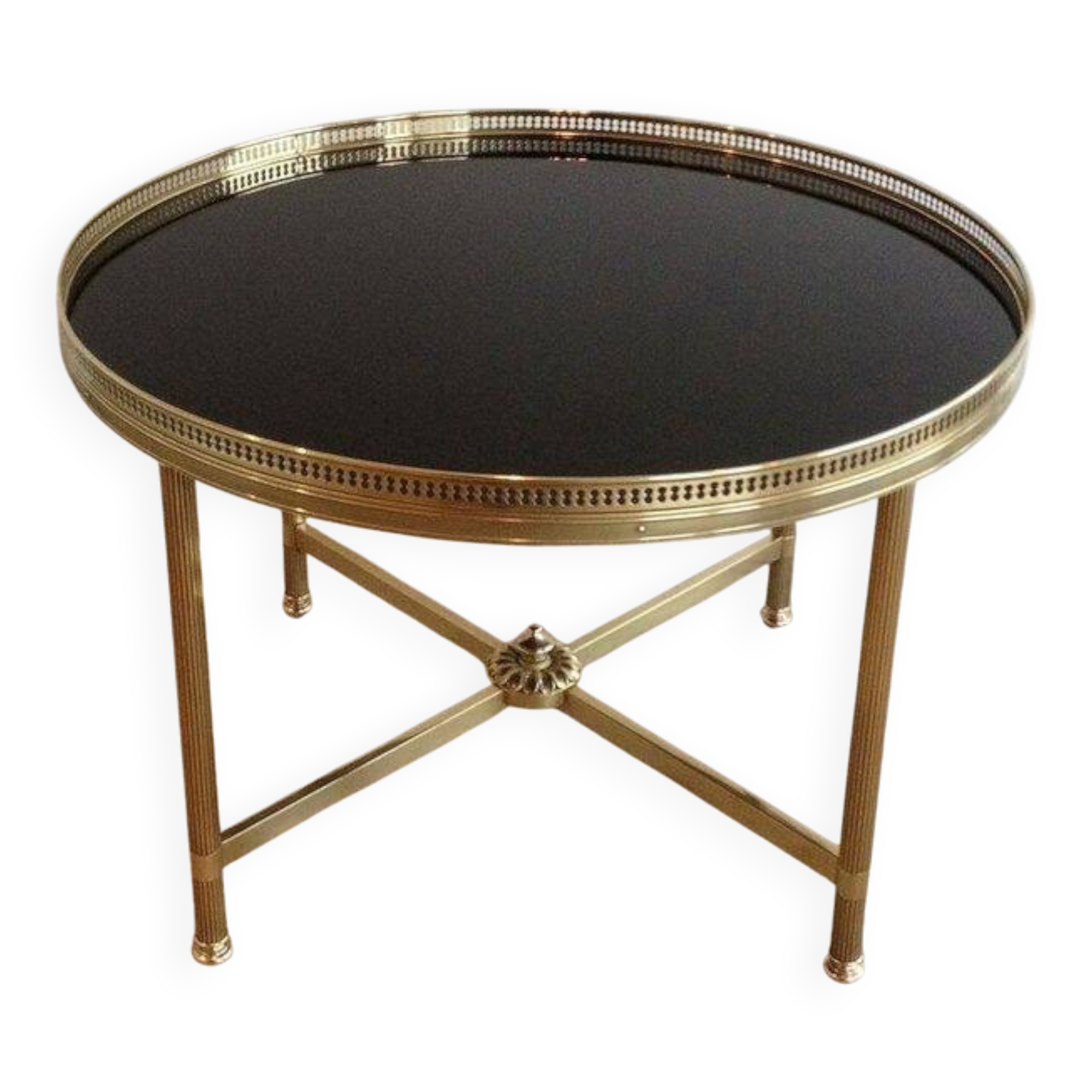 Round coffee table in brass with a black lacquered glass top by Maison Jansen.