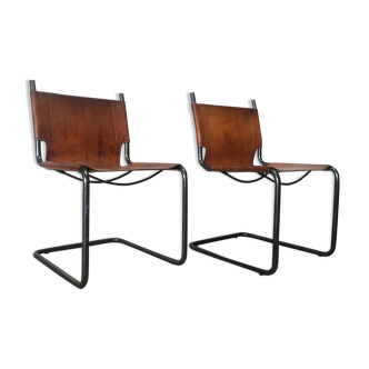 pair of tubular chairs in tawny leather