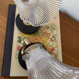 Pair of brass swan neck wall lights with transparent glass shades.